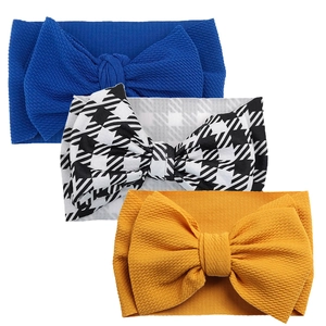 Detailed set of three baby headbands with large bows in waffle knit texture and varied colors