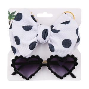 Close-up of kids heart sunglasses with gradient lenses and polka dot bow headband set