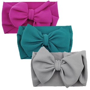Three-piece set of waffle knit baby headbands with large bows in rose, teal, and grey