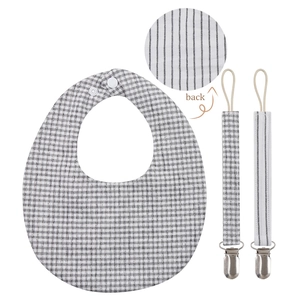 Detail showing the reversible checkered and striped patterns of this baby bib and clip set