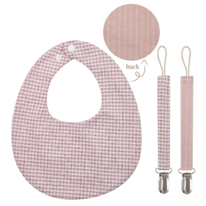 Detailed view of pink gingham baby bib with stainless metal clip and snap closure