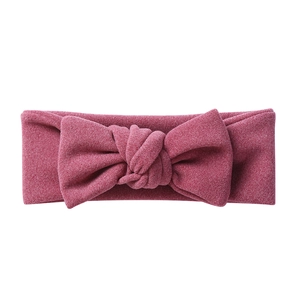 Detailed view of dark pink bow headband with soft knitted texture for infants