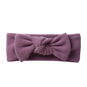 Detailed texture of dark purple velvet baby headband with oversized bow knot decoration