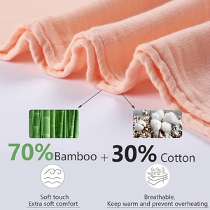 Detail of soft peach bamboo cotton baby swaddle with breathable muslin texture