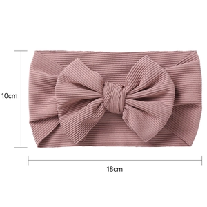 Detail view of pinkish purple ribbed knit baby headband with a large 18x10cm bow