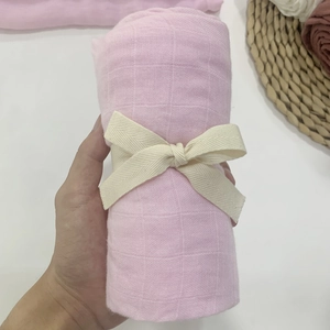 Detail of pink bamboo cotton baby wrap featuring a soft grid texture and gift ribbon bow