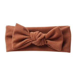 Detailed texture of caramel brown soft cashmere-like bow headband for infants