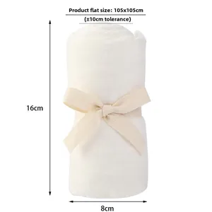Rolled white cotton baby swaddle with beige ribbon bow showing 105x105cm size
