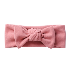 Pink elastic infant headband with a stylish knotted bow made of soft cashmere-like fabric