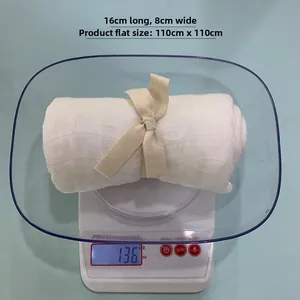 White bamboo cotton baby swaddle wrap on scale showing 110x110cm size and soft texture