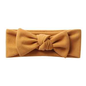 Soft mustard yellow cashmere-like baby headband with a large decorative bow tie