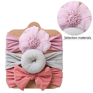 Detail view of 3-piece baby headband set showing tulle flower and donut knot designs