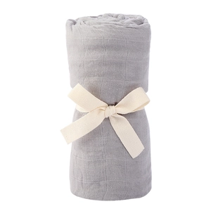 Detail of grey muslin swaddle blanket with elegant cream ribbon bow on white background