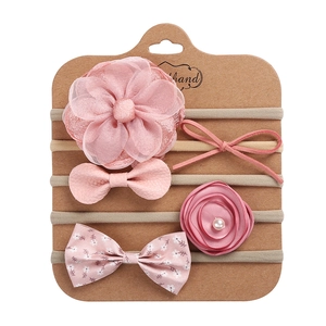 Detail of 5-piece pink baby headband set with chiffon flowers and pearls on display card