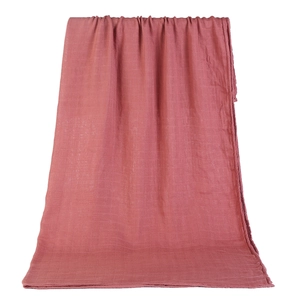 Detail showing the breathable texture of red double-layer cotton muslin swaddle blanket