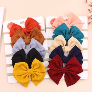 Set of 10 soft baby headbands with textured waffle fabric bows in assorted colors