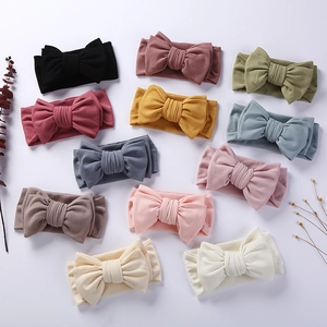 Flat lay of 11-pack baby ribbed cotton bow headbands in various soft pastel colors
