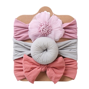 Detailed set of 3 baby headbands with pink flower, gray donut, and coral red bow