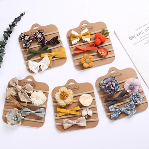 Five-piece baby headband set with floral bows and fabric flowers on display cards