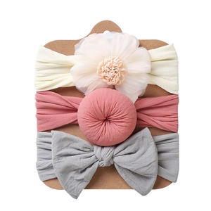 Three-piece baby headband set featuring mesh flower, round pom-pom, and large double bow knots