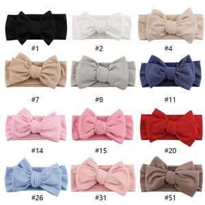 Set of 12 ribbed knit baby headbands with large bows in assorted colors for infants