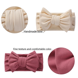 Soft ribbed baby headbands with large handmade bows in off-white and dusty pink colors