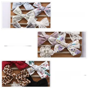 Detail of five handmade infant nylon headbands with floral prints and lace textures