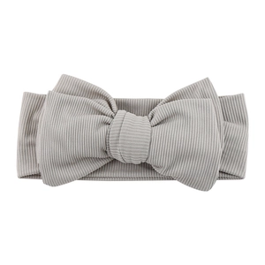Detailed close-up of ribbed fabric texture on a soft grey infant bow headband