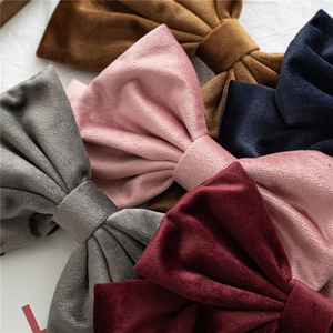 Close-up of assorted velvet bow hair clips showing premium fabric texture and vibrant colors