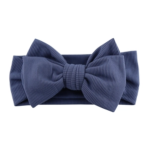 Detailed view of dark blue ribbed knit fabric texture on baby bow headband