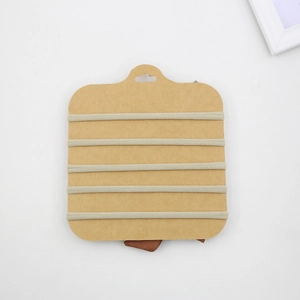 Detail view of six elastic nylon headbands on a kraft paper card for children DIY