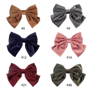Detailed collection of six colorful velvet bow hair clips with soft texture