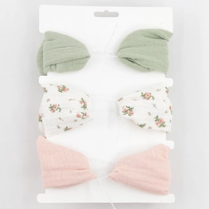Detailed view of three-piece baby bow headband set with floral and solid textured cotton fabrics