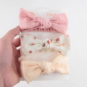 Three-pack of soft cotton baby headbands featuring pink and floral bow tie designs