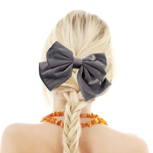 Rear view of grey satin double bow hair clip styled on a blonde braided hairstyle
