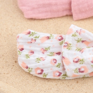 Close-up detail of soft cotton gauze baby headbands with pink floral bow and solid fabric