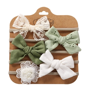 Detail of 5-piece baby headband set with lace bows and pearl flowers on display card