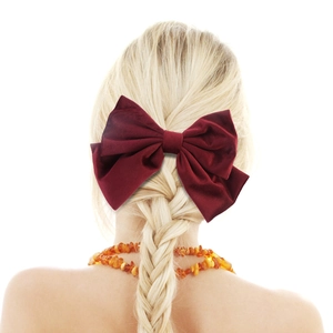 Elegant wine red oversized velvet bow hair clip worn on a blonde braided ponytail