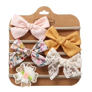Detail view of 5-piece floral and lace bow headbands on high-elastic nylon bands