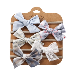 Detail of 5-piece baby headband set with lace, floral prints and nylon elastics on card