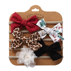 Detail view of 5-piece baby headband set with assorted bows and lace flower on card