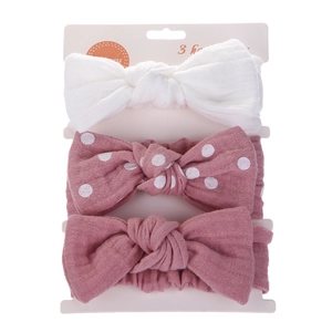 Detail of 3pcs baby headband set featuring pink polka dots and soft cotton bow textures