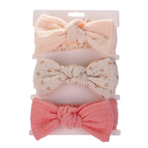 Three-piece baby headband set with soft cotton bow designs on display card