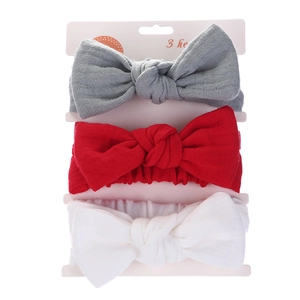 Detailed set of three baby headbands with rabbit ear bows in gray, red, and white cotton