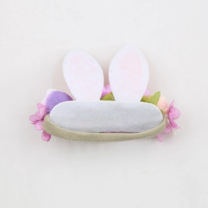 Detail of baby elastic headband featuring bunny ears with floral accents and soft nylon band
