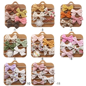 Set of 5 handmade nylon baby headbands with floral bows on kraft cards