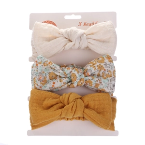 Three-piece baby headband set featuring textured cotton bows in solid and floral prints