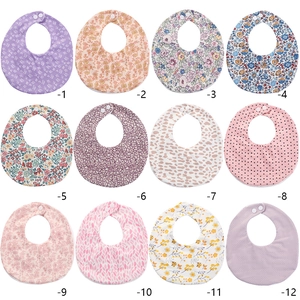 Detailed grid showing 12 different patterns of soft cotton baby bibs with snap buttons