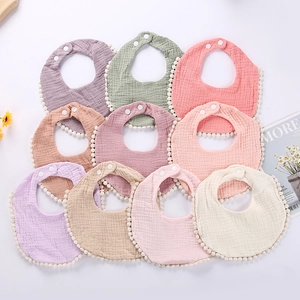 Detailed set of 10 cotton gauze baby bibs with cute pom-pom trim and adjustable snaps