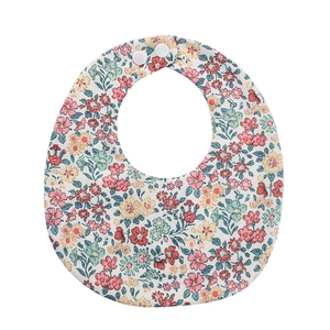 Detail of floral baby bib with red and pink flower print and adjustable white snap buttons